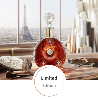 A lifestyle image of LOUIS XIII City of Lights decanter on a table, Eiffel Tower in the backgroundd. Stamp Limited Edition