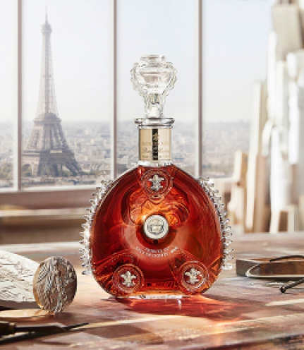 A lifestyle photo of LOUIS XIII decanter on a table, Eiffel Tower in the background