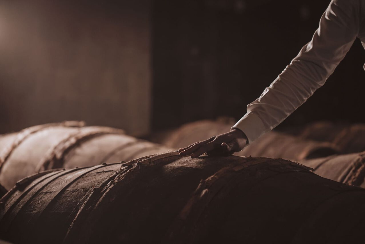 A lifestyle photo of a hand touching a barrel