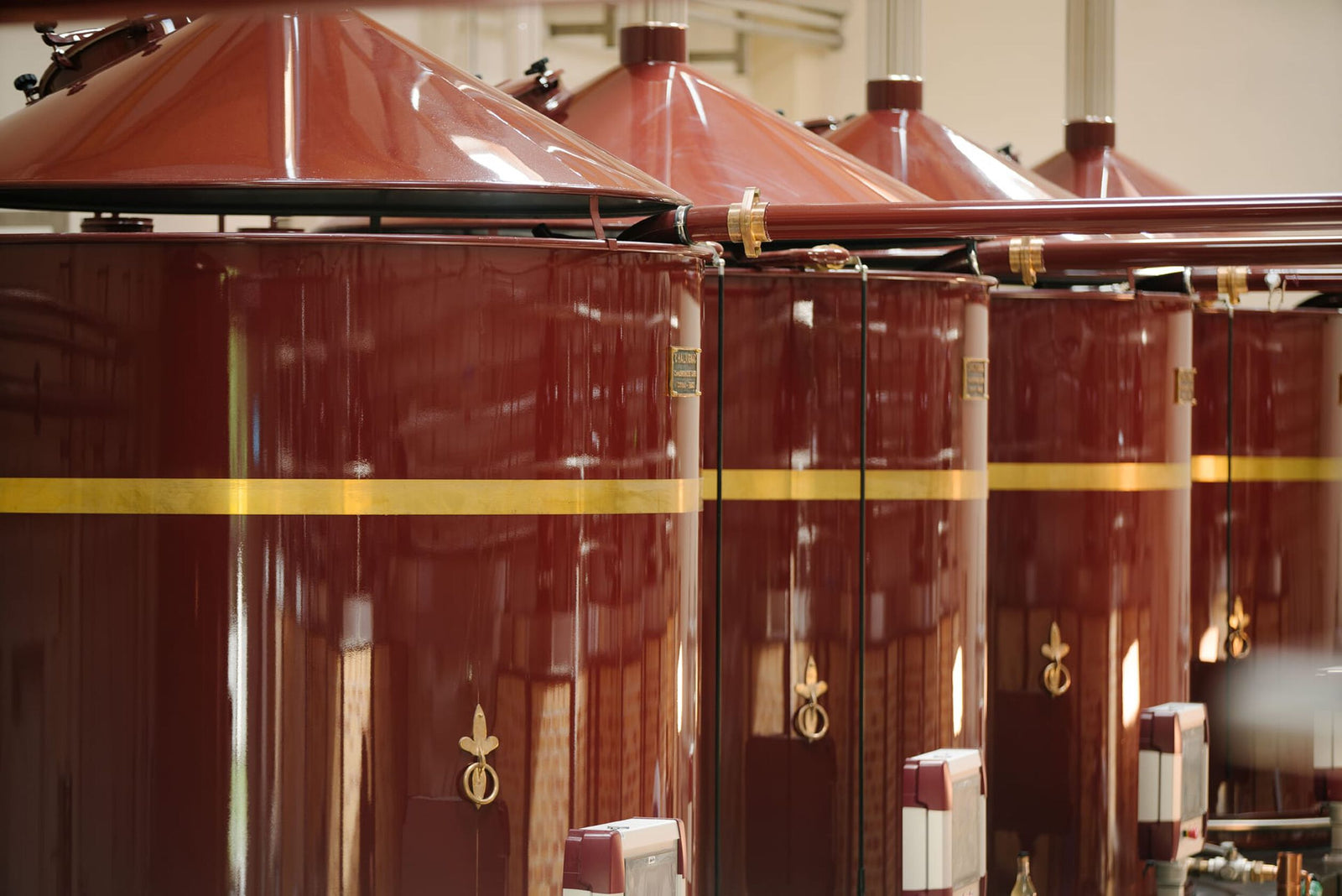 An image of brown distilation tanks with connecting pipes