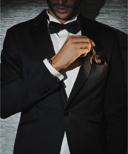 A photo of a well dressed man putting The Miniature in the upper pocket