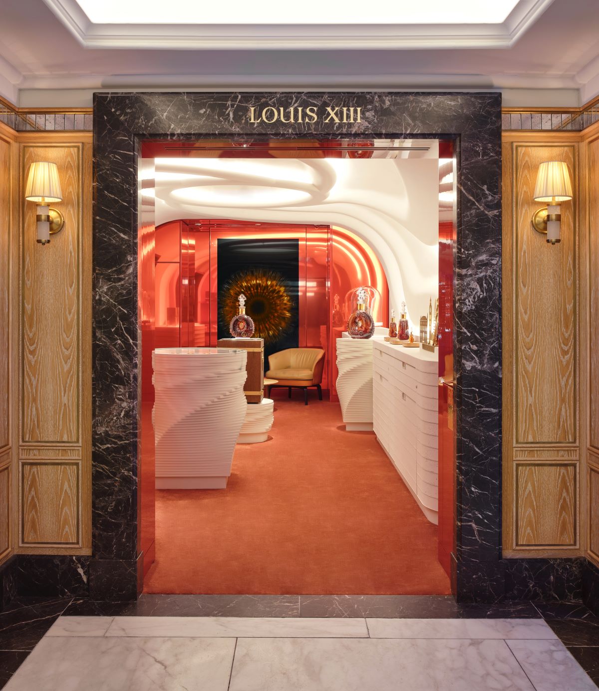 A photo of the entry to Harrods boutique in London, with LOUIS XIII decanter on the display