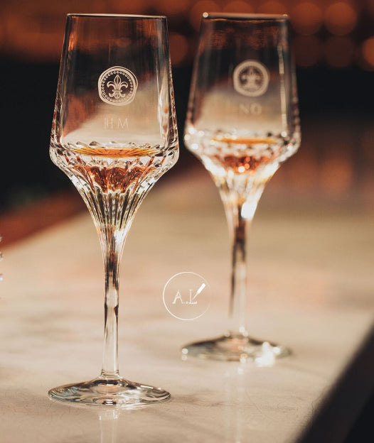 A lifestyle photo of two LOUIS XIII crystal glases with cognac on a bar countertop
