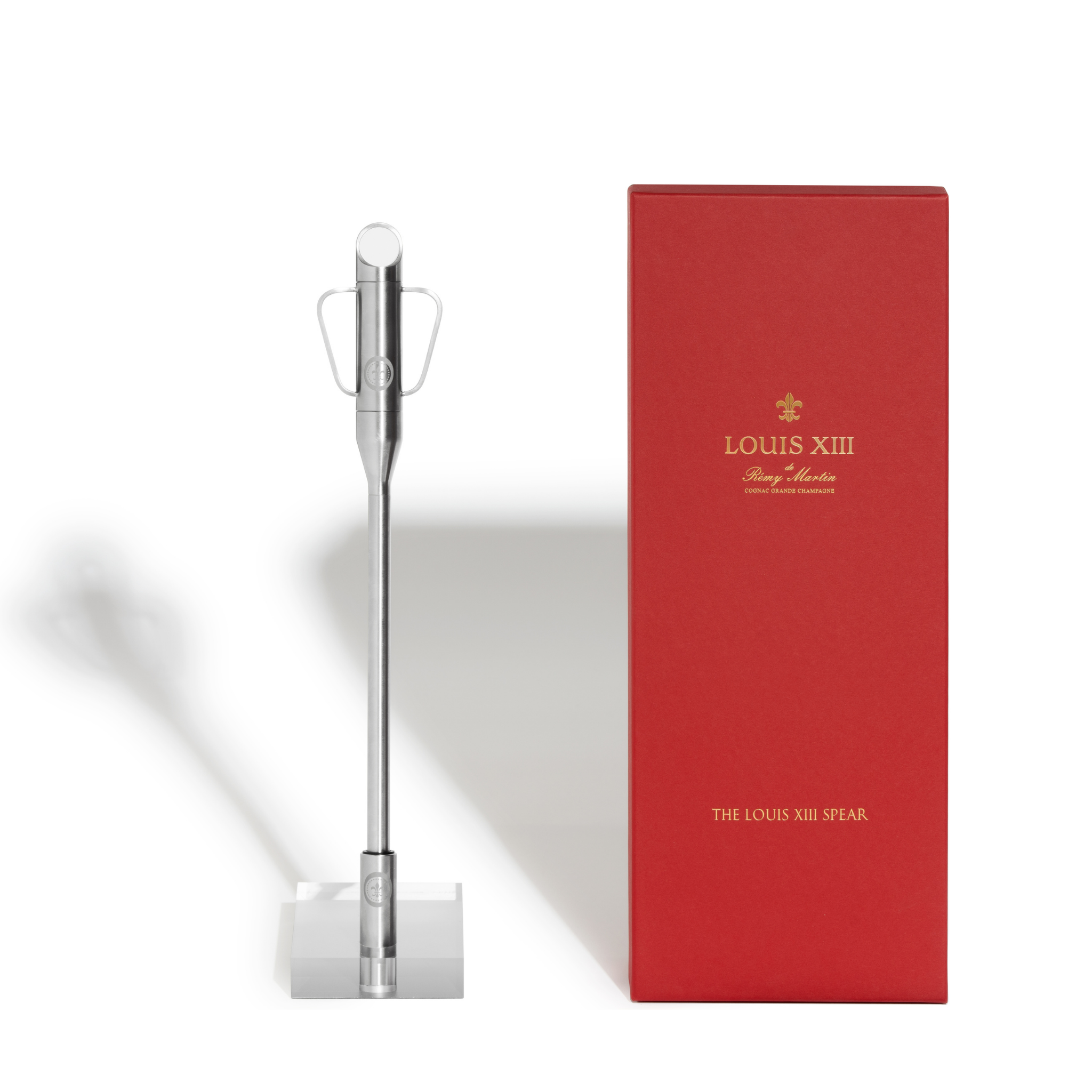 A packshot of a spear for Magnum decanter with its holder, close to its red packaging